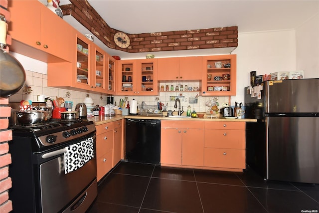 kitchen with decorative backsplash, sink, dark tile patterned flooring, and appliances with stainless steel finishes