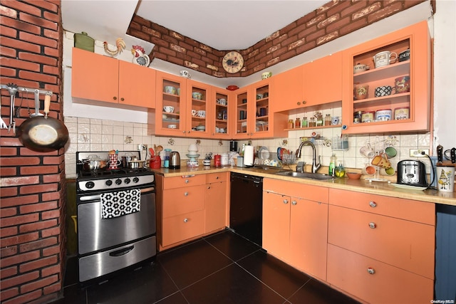 kitchen with gas stove, dishwasher, sink, dark tile patterned floors, and brick wall