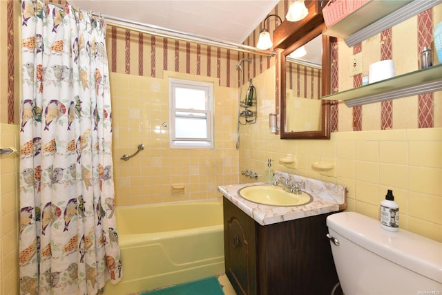 full bathroom featuring vanity, toilet, tile walls, and shower / tub combo with curtain