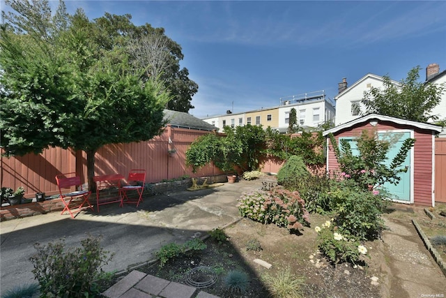 view of yard featuring a shed and a patio area