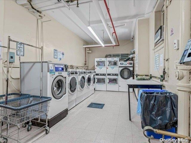 clothes washing area with separate washer and dryer