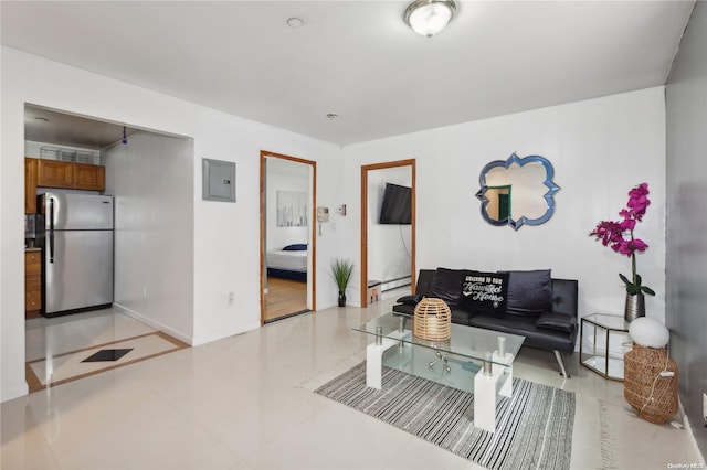 living room featuring light tile patterned floors, electric panel, and a baseboard radiator