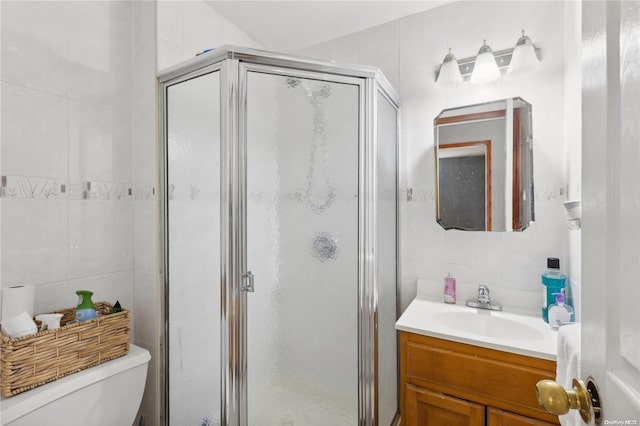 bathroom with toilet, tile walls, and walk in shower