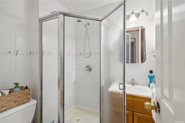 bathroom with vanity, toilet, and walk in shower