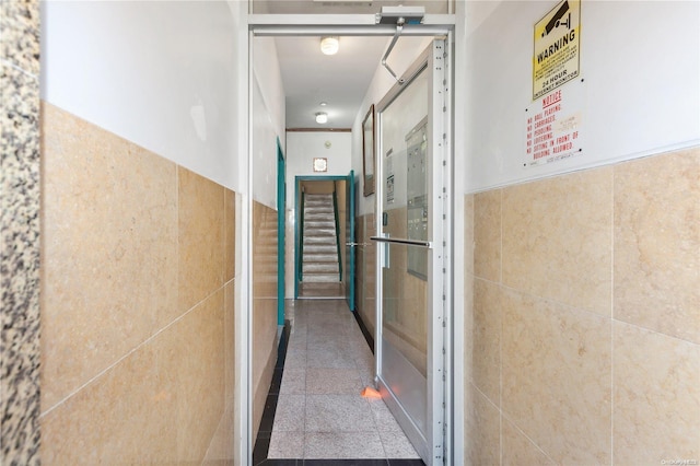 hallway with tile walls