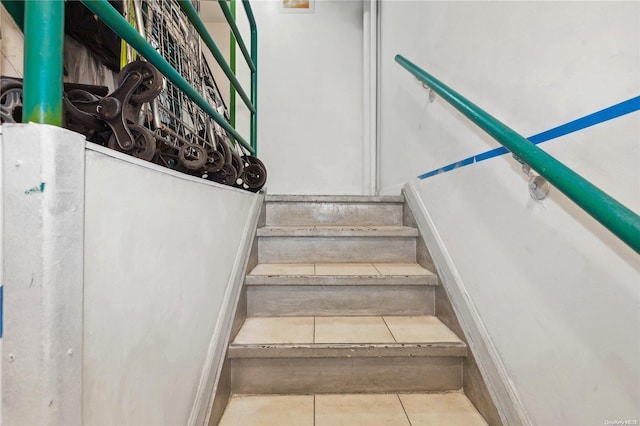 staircase with tile patterned floors