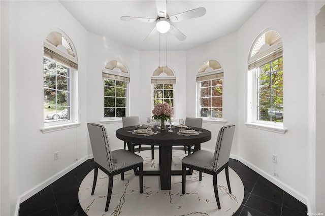 tiled dining room featuring plenty of natural light and ceiling fan