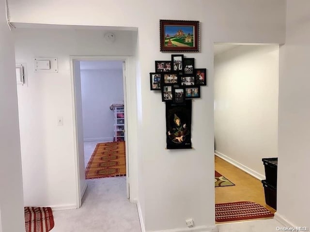 hallway featuring light carpet