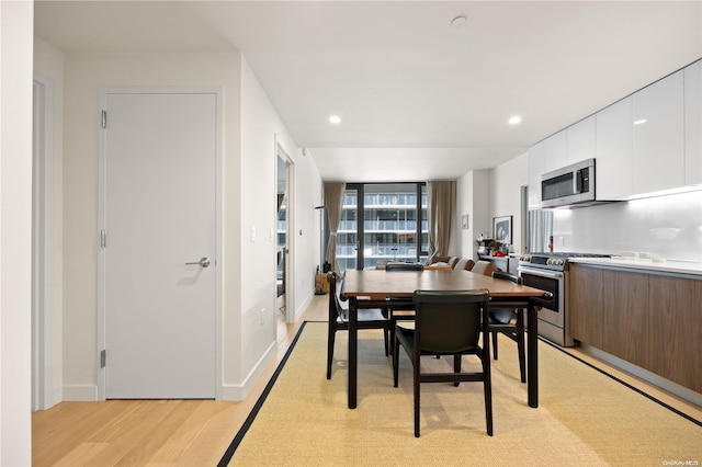 dining space with light hardwood / wood-style flooring