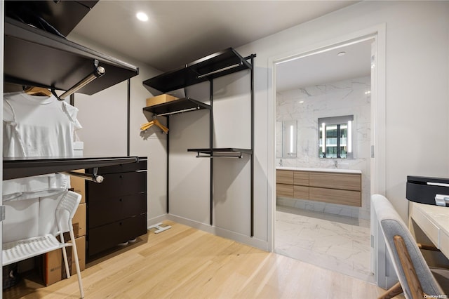 walk in closet featuring light hardwood / wood-style floors