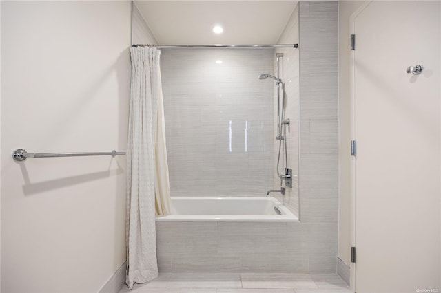 bathroom featuring tile patterned flooring and shower / bath combination with curtain