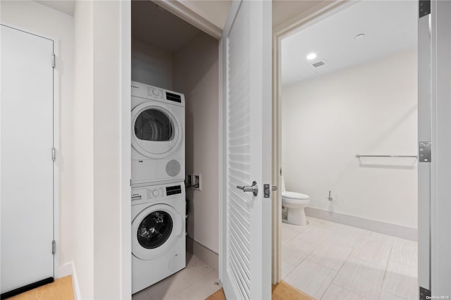 laundry area featuring stacked washer and clothes dryer