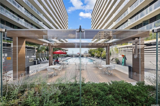 view of patio / terrace with a swimming pool side deck and a pergola