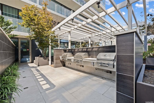 view of patio / terrace with area for grilling and a pergola