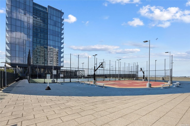 view of home's community with basketball hoop