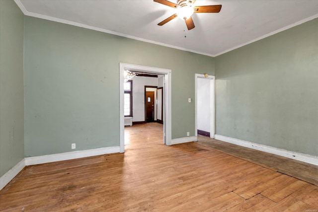 spare room featuring ceiling fan, crown molding, and light wood-type flooring