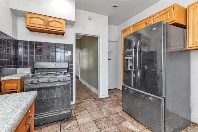 kitchen with backsplash and black appliances