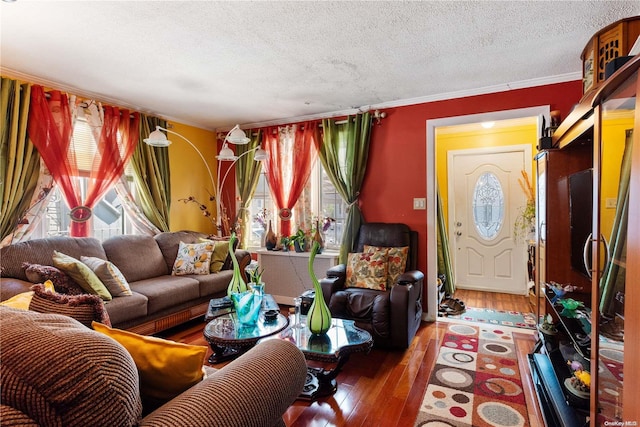 living room with ornamental molding, a textured ceiling, and hardwood / wood-style flooring