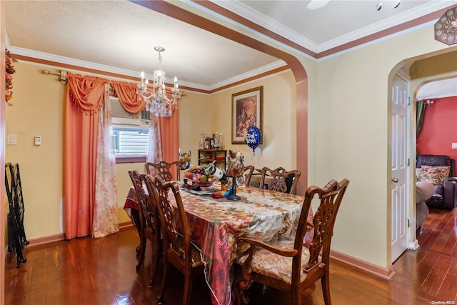 dining space with dark hardwood / wood-style floors, ornamental molding, and an inviting chandelier