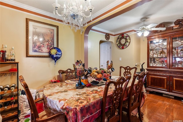 dining room with ceiling fan with notable chandelier, dark hardwood / wood-style flooring, and ornamental molding