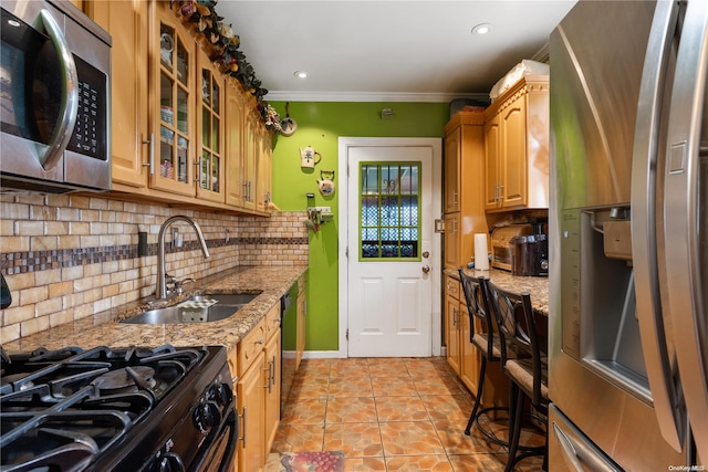 kitchen featuring decorative backsplash, light stone counters, ornamental molding, sink, and black appliances