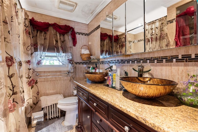 bathroom with vanity, toilet, tile walls, and crown molding