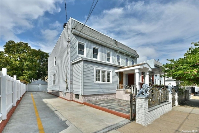 view of front facade featuring an outbuilding and a garage