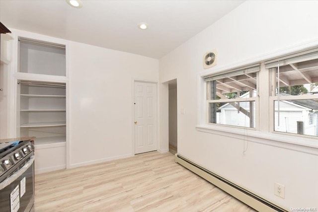 interior space with light hardwood / wood-style flooring and baseboard heating