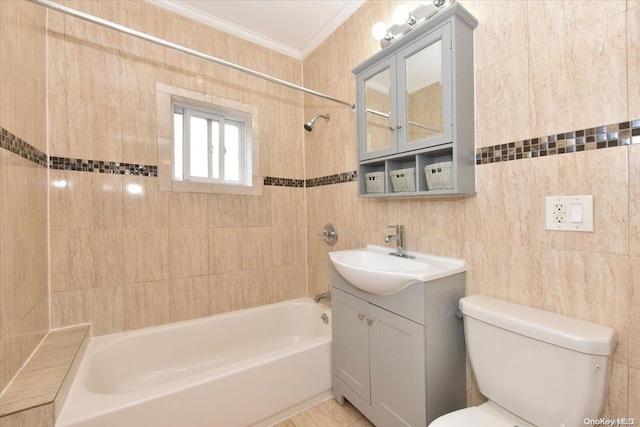 full bathroom featuring ornamental molding, toilet, vanity, tile walls, and tiled shower / bath