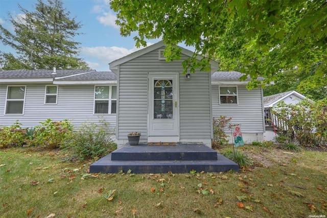 rear view of house with a yard