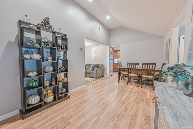 interior space with hardwood / wood-style floors and high vaulted ceiling