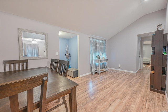 dining area featuring light hardwood / wood-style floors and lofted ceiling