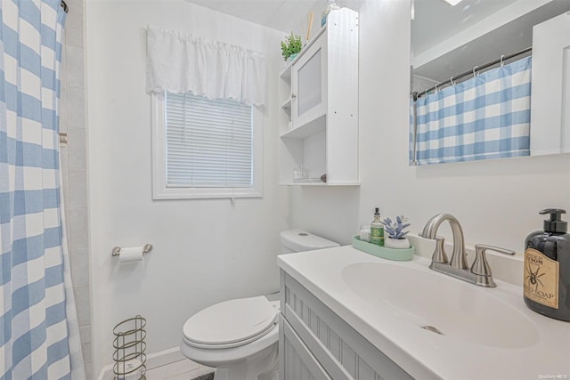 bathroom with a shower with curtain, vanity, and toilet