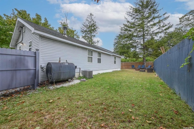 rear view of house with a yard and central air condition unit