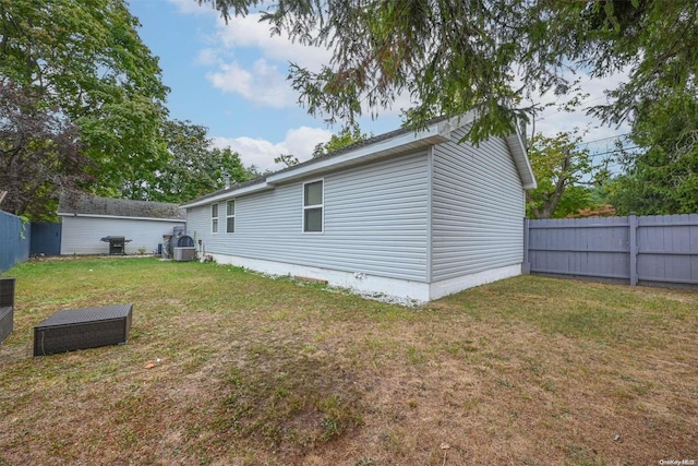 back of house with a lawn