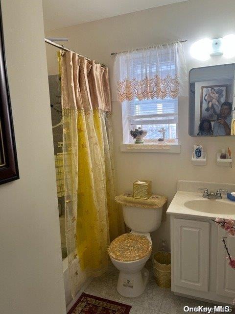 full bathroom featuring tile patterned flooring, shower / bath combo, vanity, and toilet