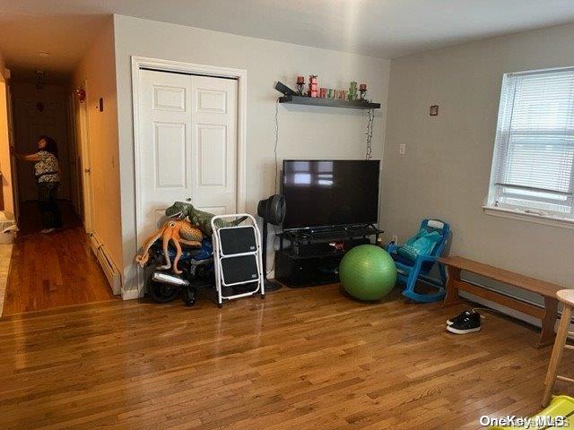 interior space featuring hardwood / wood-style floors and baseboard heating