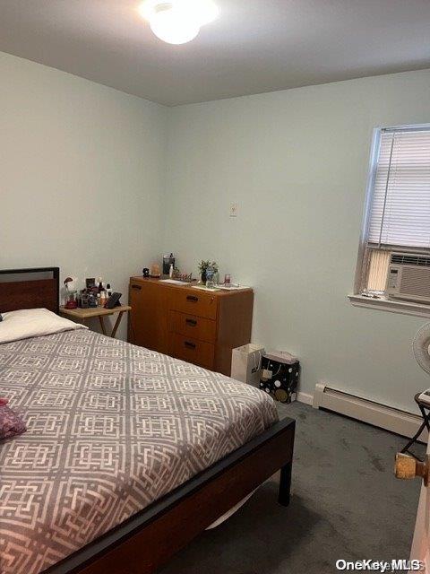 bedroom with carpet flooring, baseboard heating, and cooling unit