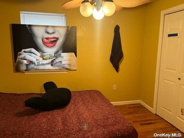 bedroom with wood-type flooring and ceiling fan