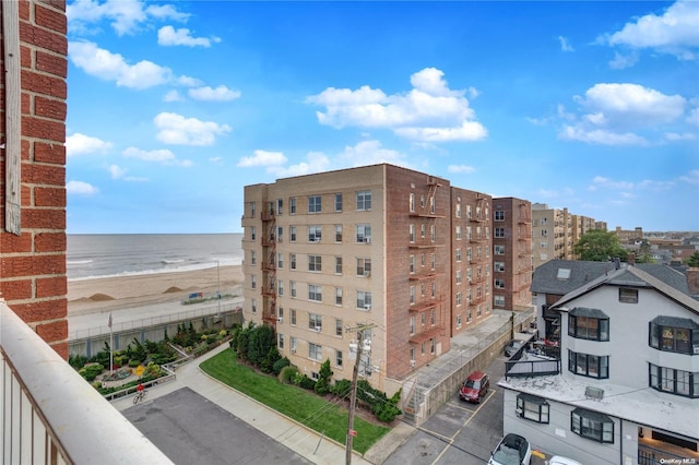 view of property with a water view and a view of the beach