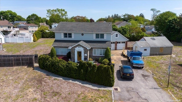 view of property featuring a garage and an outdoor structure