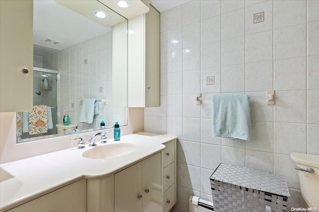 bathroom featuring vanity, a baseboard radiator, tile walls, and toilet