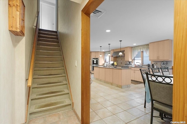 staircase with tile patterned floors and sink