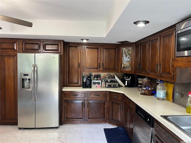 kitchen with ceiling fan, sink, backsplash, dark brown cabinets, and appliances with stainless steel finishes