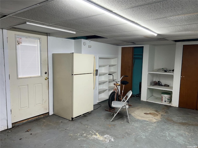 basement with white refrigerator