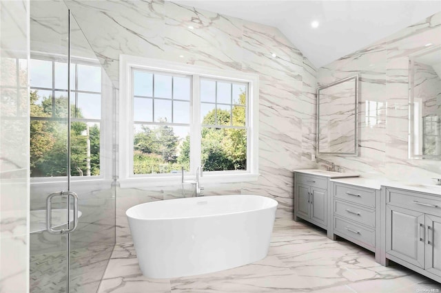 bathroom with vanity, lofted ceiling, tile walls, and plus walk in shower