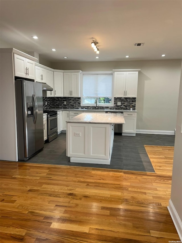 kitchen featuring white cabinets, appliances with stainless steel finishes, and dark wood-type flooring