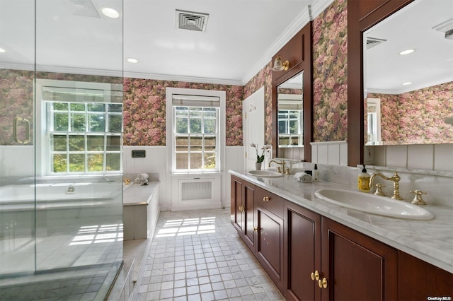 bathroom featuring tile patterned floors, vanity, a bathtub, and crown molding