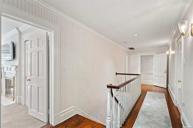 hall with hardwood / wood-style flooring and ornamental molding