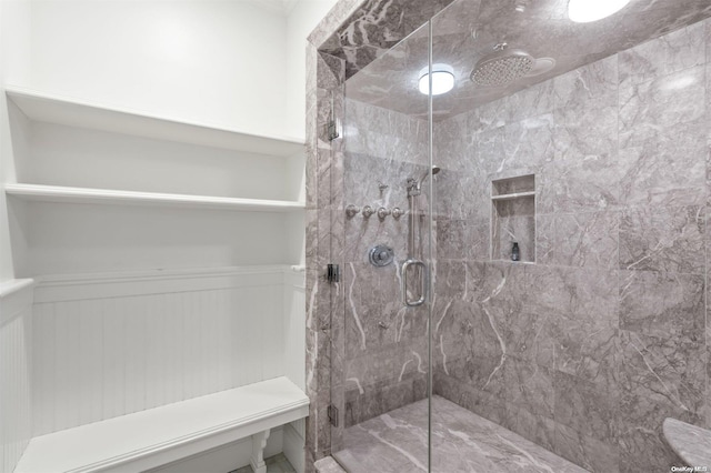 bathroom featuring a shower with door